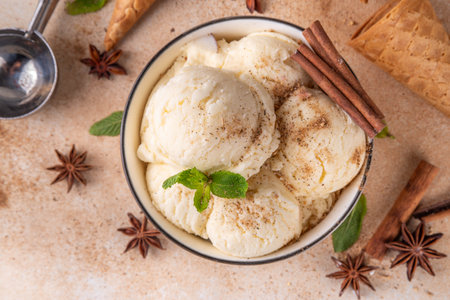 Indian cold summer Garam Masala Gelato dessert, Indian Three Spice Ice Cream in white ceramic bowl, with mint leaves, spices and waffle ice cream conesの写真素材