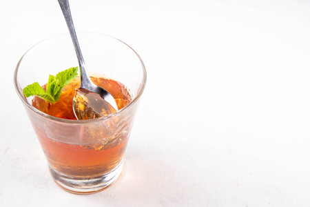 Black tea trendy Asian dessert, diet non calorie sweet tea agar or gelatine jelly, in portioned glass, white table background copy spaceの写真素材