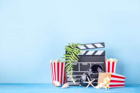Summer holiday and vacation movie cinema marathon background Cinema clapper-board with sunglasses, seashells, starfish, popcorn buckets, vacation accessories, Cinema for the summer Movie Night partyの写真素材