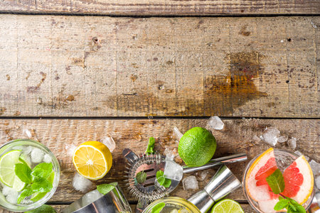 Summer detox beverage concept. Citrus fruit drinks with ice. Healthy diet cocktail with making bar tools. Vitamin fortified waterの写真素材