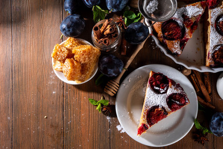 Autumn new york plum pie, tasty cinnamon spices plum torte cake on rustic cozy wooden background, copy spaceの写真素材