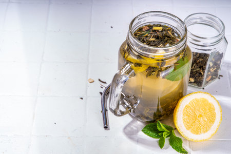 Homemade cold brew tea. Set of various healthy summer drink, cold slow brewed tea in mason jar, summer cold or hot  beverages, on white background copy spaceの写真素材