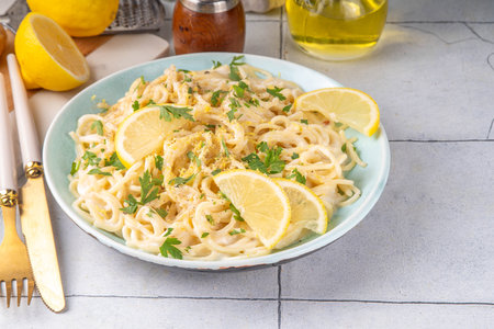 Homemade lemon pepper pasta, al limone spaghetti with creamy sauce with with lemon and pepper, copy spaceの写真素材