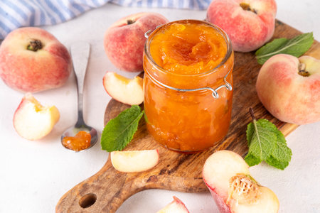 Flat chinese donuts fig peach jam, homemade confiture preserves with fresh fig peaches and mint in white background copy spaceの写真素材