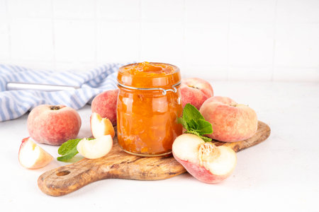 Flat chinese donuts fig peach jam, homemade confiture preserves with fresh fresh fig peaches and mint in white background copy spaceの写真素材
