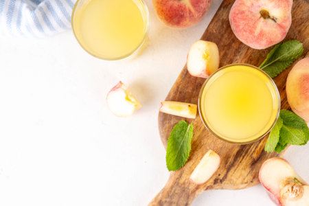Flat peach juice with fresh fig peaches and mint in white background copy spaceの写真素材