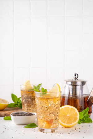 Iced chia seeds tea or lemonade, trendy healthy refreshing chia infused drink, alternative natural energy source, diet weight-loss drink, with mint, lemon and crushed ice, copy spaceの写真素材