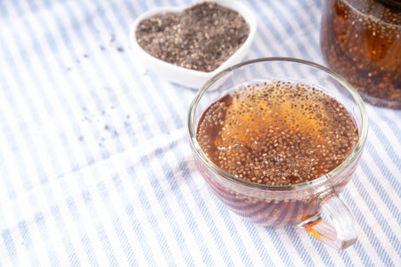 Chia seeds tea, trendy healthy chia infused drink, alternative natural energy source, diet weight-loss drink, in teapot and tea cup, copy spaceの写真素材