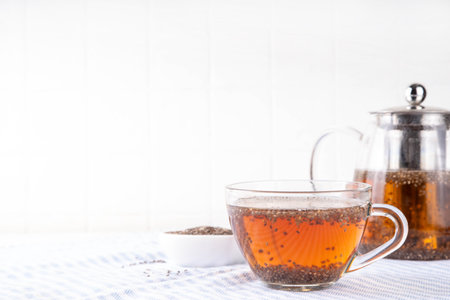 Chia seeds tea, trendy healthy chia infused drink, alternative natural energy source, diet weight-loss drink, in teapot and tea cup, copy spaceの写真素材