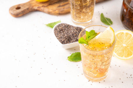 Iced chia seeds tea or lemonade, trendy healthy refreshing chia infused drink, alternative natural energy source, diet weight-loss drink, with mint, lemon and crushed ice, copy spaceの写真素材