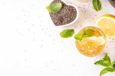 Iced chia seeds tea or lemonade, trendy healthy refreshing chia infused drink, alternative natural energy source, diet weight-loss drink, with mint, lemon and crushed ice, copy spaceの写真素材