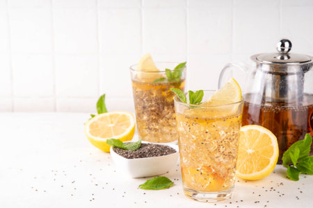 Iced chia seeds tea or lemonade, trendy healthy refreshing chia infused drink, alternative natural energy source, diet weight-loss drink, with mint, lemon and crushed ice, copy spaceの写真素材