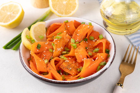 Viral trendy asian carrot salad with apple or wine vinegar, a little oil and salt, also known as Carrot Ribbon Salad. Trending carrot salad recipe, source of beta-carotene, healthy diet foodの写真素材