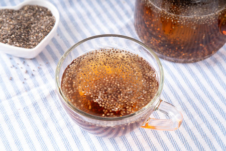Chia seeds tea, trendy healthy chia infused drink, alternative natural energy source, diet weight-loss drink, in teapot and tea cup, copy spaceの写真素材