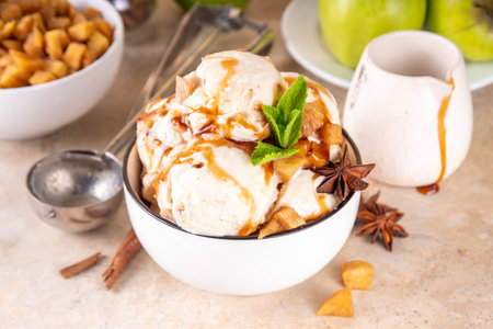 Homemade apple pie ice cream. Bowl of traditional autumn apple pie or strudel gellato, with caramelized apples, sponge cake biscuit crumble, caramel sauce, cinnamon and spicesの写真素材