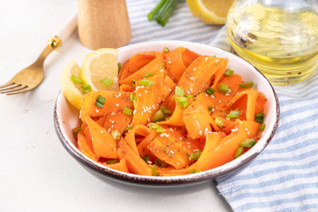 Viral trendy asian carrot salad with apple or wine vinegar, a little oil and salt, also known as Carrot Ribbon Salad. Trending carrot salad recipe, source of beta-carotene, healthy diet foodの写真素材