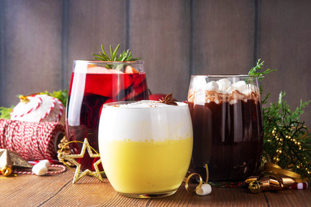 Hot drink cafes menu background, with mulled wine, eggnog and hot chocolate traditional Christmas winter cocktails and beverages, with Christmas New Year festive holiday decorations, copy spaceの写真素材
