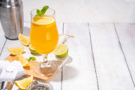 Trendy Tea Inspired cocktail set from green, oolong, black, chai and other tea blends. Sparkling tea soda, cold summer drinks with syrup, lemon, lime and mint, on sun lighted white wooden backgroundの写真素材
