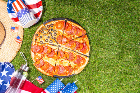 july 4th holiday party pizza, Fourth of July, Patriotic Independence day festive and picnic food. Pepperoni, tomato and black olive pizza with lot of mozzarella, in form of American flagの写真素材