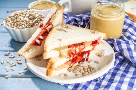 Traditional American breakfast sandwich toast with alternative not nut butter - sunflower seeds paste and vegan organic jam. Healthy alternative non-allergenic food concept  copy spaceの写真素材