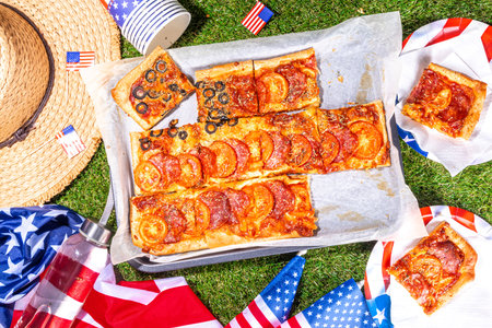 july 4th holiday party pizza, Fourth of July, Patriotic Independence day festive and picnic food. Pepperoni, tomato and black olive pizza with lot of mozzarella, in form of American flagの写真素材