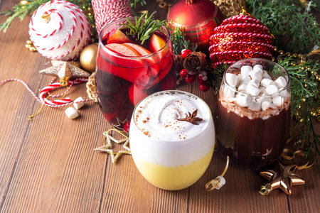 Hot drink cafes menu background, with mulled wine, eggnog and hot chocolate traditional Christmas winter cocktails and beverages, with Christmas New Year festive holiday decorations, copy spaceの写真素材