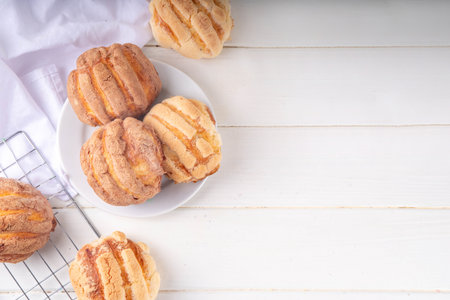 Mexican traditional conchas pastry, cookie or bread buns. Homemade conchas dessert pastry, on baking sheet with man hands in pic, top view copy spaceの写真素材