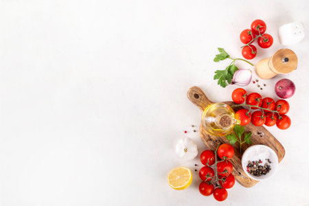Spices, black pepper, garlic, onion, greens and tomatoes, olive oil on white cooking table. Ingredients for cooking food on the white stone concrete background top view copy space.の写真素材