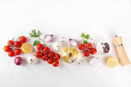 Spices, black pepper, garlic, onion, greens and tomatoes, olive oil on white cooking table. Ingredients for cooking food on the white stone concrete background top view copy space.の写真素材