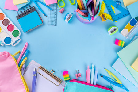 School equipment high-colored bright blue flat lay. Various school education and office supplies, accessories. Back to school sale background top view copy spaceの写真素材