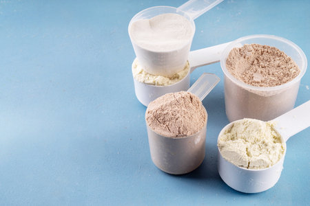 Different protein flavors in plastic scoops. Protein powder shakes for weight loss, set every day protein goals, sport and fitness, healthy lifestyleの写真素材