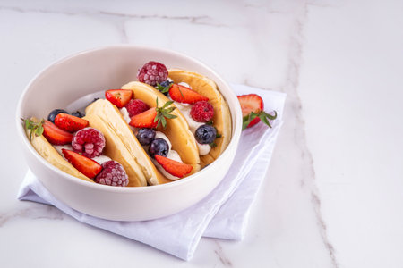 Pancake tacos. Portion of sweet dessert taco made with pancake, whipped cream, cottage cheese or ice cream, fruit and berries. Summer breakfast or brunch recipe, copy spaceの写真素材