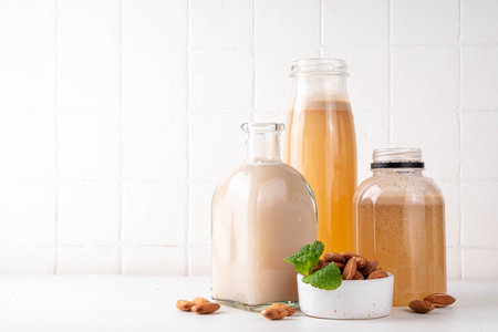 Homemade almond Orgeat Syrup in different bottles, almonds, water, sugar, and orange flower water syrup for making sweet cocktailsの写真素材