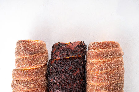 Traditional East Europe Christmas sugar glazed dessert chimney cake, trdlo or trdelnik, sweet aromatic winter seasonal street food with cinnamon and spicesの写真素材