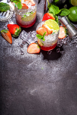 Strawberry citrus summer cooling drink, iced berry mojito lemonade with strawberries, mint and limeの写真素材
