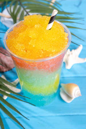 Colorful slushie drink, multicolored frozen juice cocktail, summer tropical crushed ice beverageの写真素材