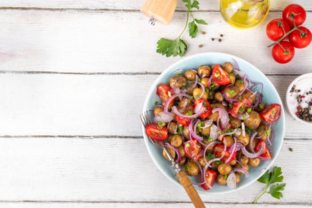 Summer young potatoes salad, with baby potato, onions, tomatoes, olive oil. Summer barbeque and picnic recipe ideas, vegan comfort foodの写真素材
