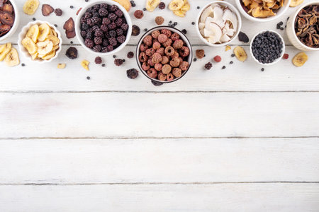 Freeze-Dried Fruits berry, alternative way to store summer harvest. Bowls with dried dehydrated raspberry, blueberry, peach, banana, apricot, plum, blackberry, apple, cherry on white wood backgroundの写真素材