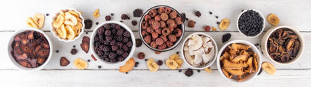 Freeze-Dried Fruits berry, alternative way to store summer harvest. Bowls with dried dehydrated raspberry, blueberry, peach, banana, apricot, plum, blackberry, apple, cherry on white wood backgroundの写真素材