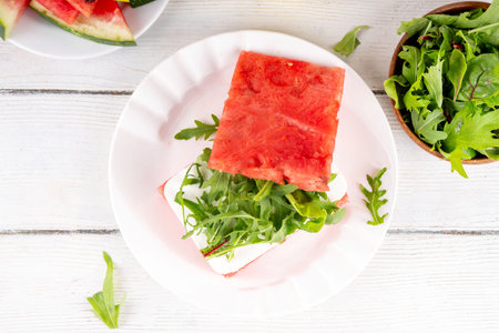 Viral watermelon sandwich burger with feta and arugula, summer picnic and bbq refreshment appetizer  food, on white kitchen table copy spaceの写真素材