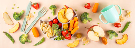 Baby finger food, various baby snacks, pasta, vegetables, fruits chopped for convenient, safe children's lunch, teaching small child to eat healthy foodの写真素材
