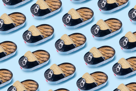 Sardinecore trend concept, canned sardines in metal can on a blue background, on plate with a fork and knifeの写真素材