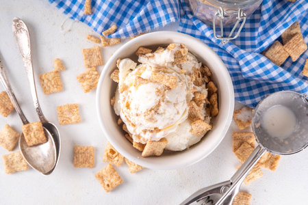 Cinnamon Toast Crunch ice cream with cinnamon sugar and caramel, small portion bowl with a lot of...