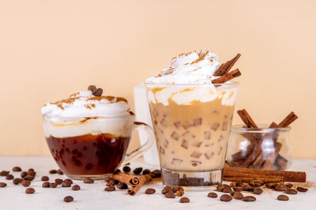 Iced cinnamon latte with whipped cream, cinnamon syrup and cinnamon powder on top, with coffee beans...