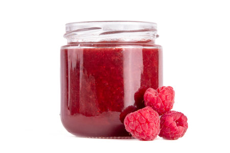 Raspberry in small jar. Homemade sweet berry marmalade confiture with fresh fruits. Fall...