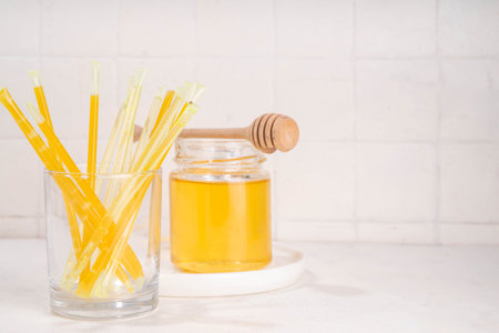 Homemade honey sticks. Portable straws with golden honey, healthy organic treatの写真素材