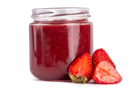Strawberry in small jar. Homemade sweet berry marmalade confiture with fresh fruits. Fall preparations, fruit preserves canning isolated on white backgroundの写真素材