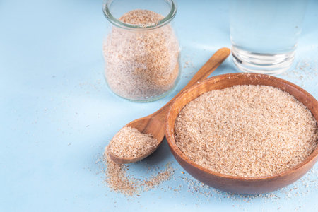 Whole Psyllium Husk in spoon, bowl and jar, with glass of water, natural alternative to pills or...