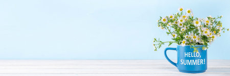 Hello summer seasonal and holiday background, with a bouquet of daisy chamomile flowers and summer straw hat, copy spaceの写真素材