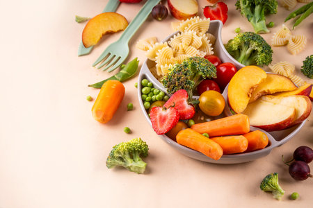 Baby finger food, various baby snacks, pasta, vegetables, fruits chopped for convenient, safe children's lunch, teaching small child to eat healthy foodの写真素材